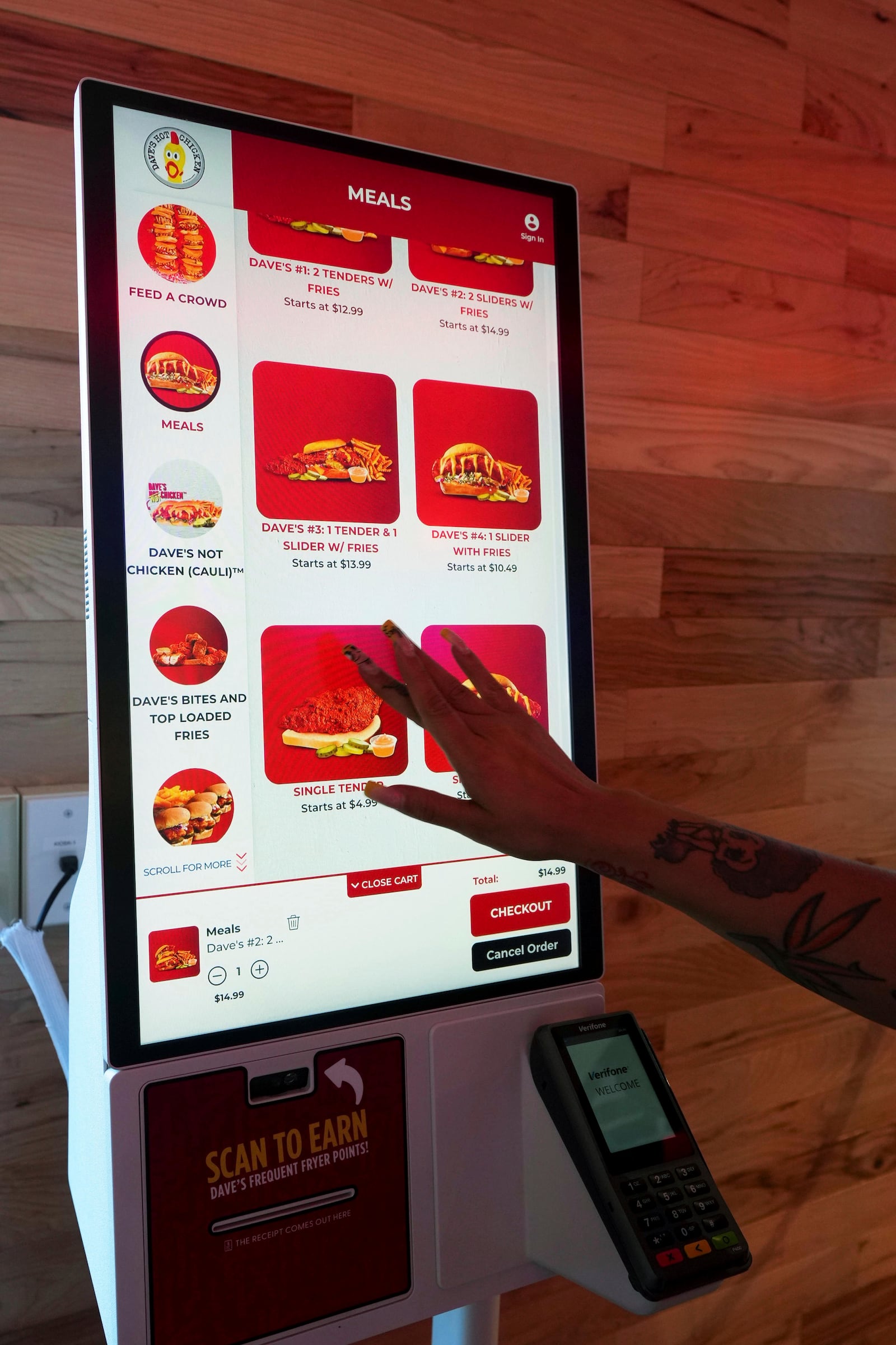 A customer uses a touch screen to order inside Dave's Hot Chicken restaurant in the Little Tokyo district of Los Angeles Monday, June 2, 2025. (AP Photo/Damian Dovarganes)