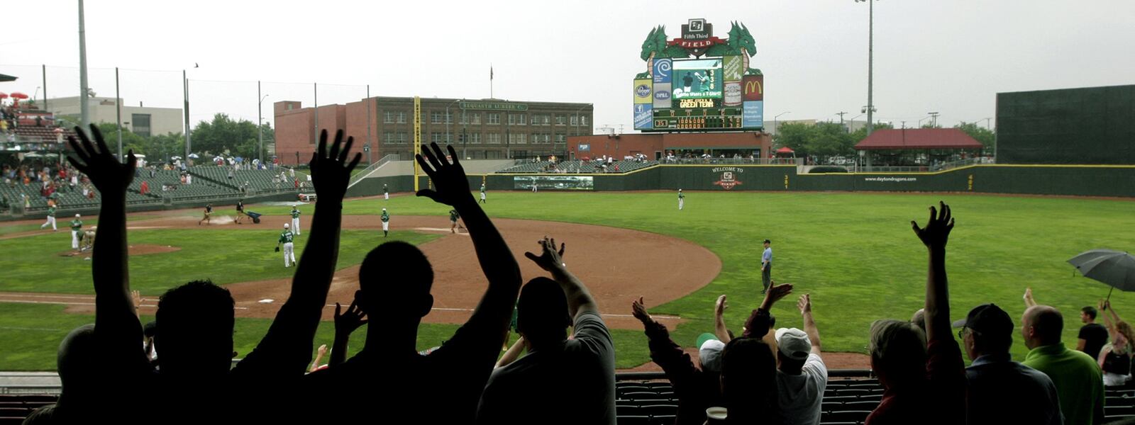 Fans cheer on the Dayton Dragons at Fifth Third Field in Dayton. LISA POWELL/STAFF