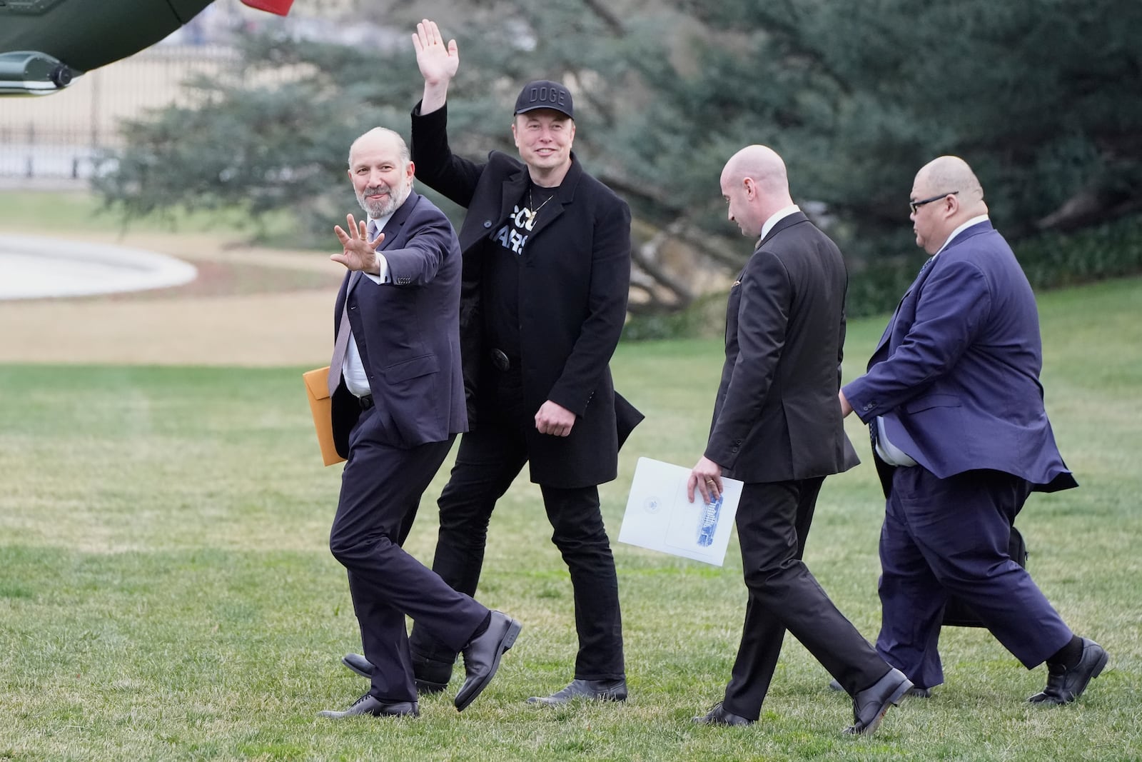 FILE - From left, Commerce Secretary Howard Lutnick, Elon Musk, Stephen Miller and Steven Cheung walk to board Marine One with President Donald Trump on the South Lawn of the White House, March 14, 2025, in Washington. (AP Photo/Alex Brandon, File)
