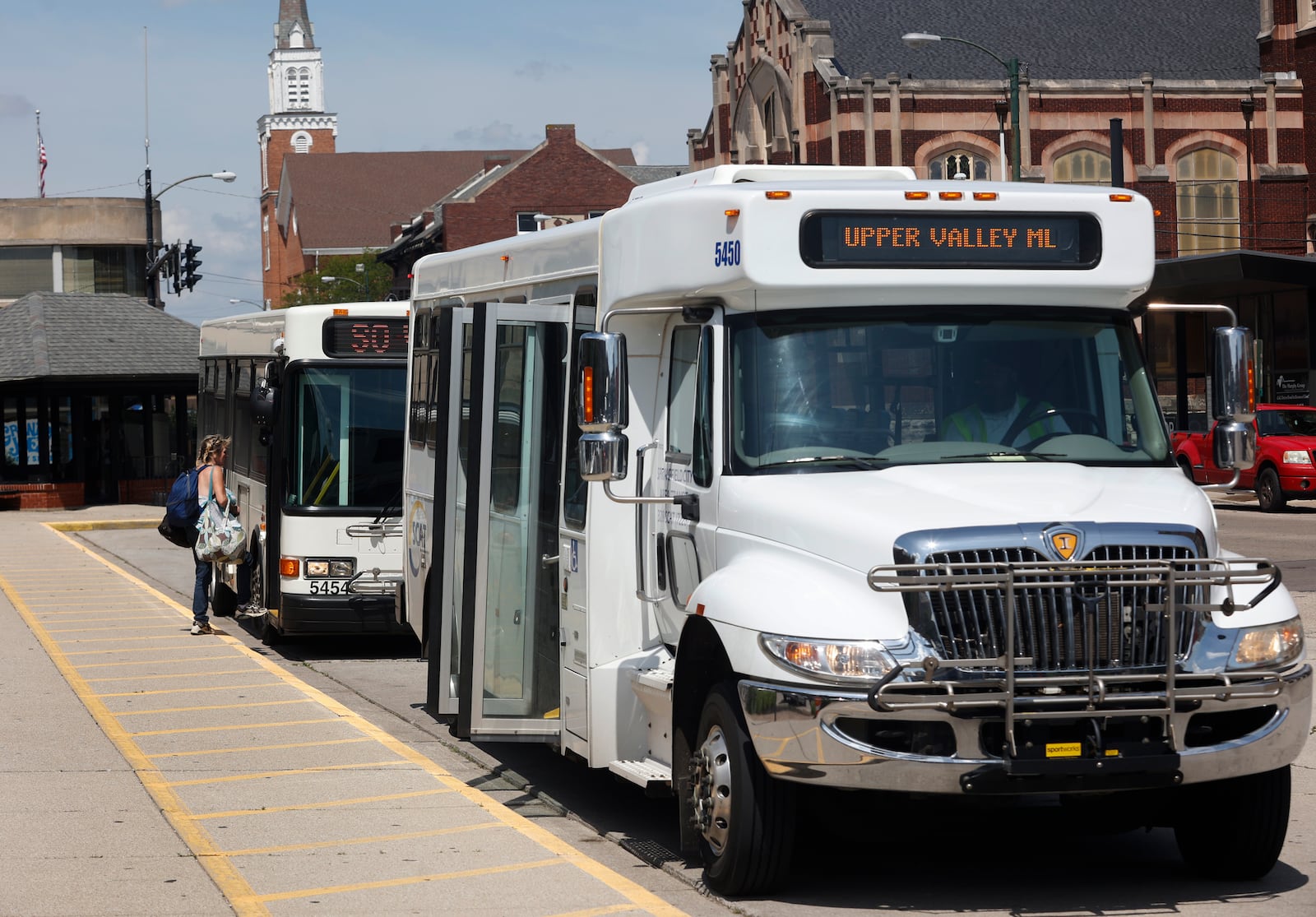 A woman enters a SCAT bus on West High Street on the afternoon of Friday, June 20, 2025, in Springfield. JOSEPH COOKE/STAFF
