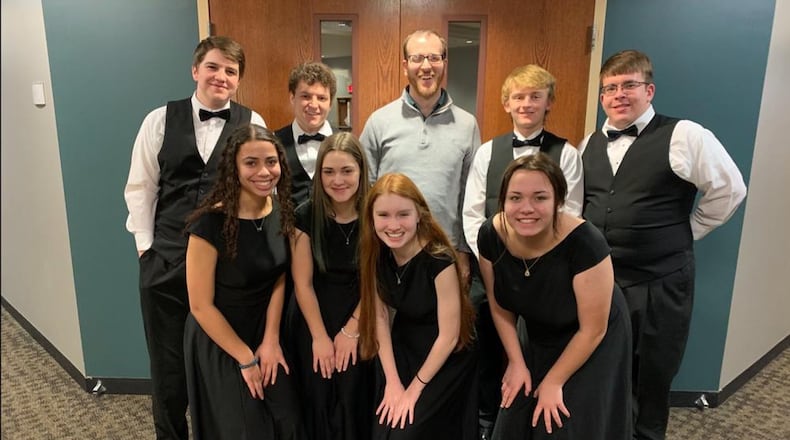 Brice Henry, center, Director of Choirs at West Liberty-Salem Local School District, was named the Springfield Symphony Orchestra’s Music Educator of the Year and will be honored at the Symphony’s concert on Saturday. Courtesy photo