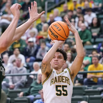 Wright State freshman guard Michael Cooper shoots with pressure from Cleveland State's Priest Ryan during a Horizon League Championship first-round game on Wednesday, March 4 at Ervin J. Nutter Center in Fairborn. BRYANT BILLING / STAFF