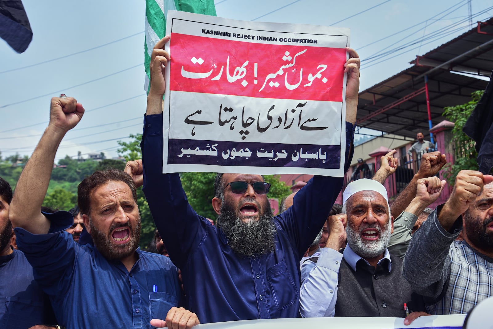 Supporters of Pasban-e-Hurriyat Jammu and Kashmir chant slogans during an anti-India demonstration, in Muzaffarabad, the capital of Pakistan administered Kashmir, Monday, May 5, 2025. The placard in the center reads "Jammu and Kashmir want idepdendenoe from India". (AP Photo/M.D. Mughal)
