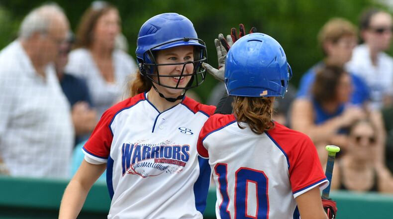 Northwestern senior Abby Zerkle (left) claps hands with Rachel Martin after scoring a run in a regional final against Columbus Ready on Saturday at Wright State. BRYANT BILLING / CONTRIBUTED