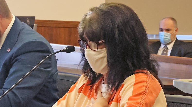 Valerie Rider reads a statment during the sentencing for her murder conviction in Champaign County Common Pleas Court Thursday. The victim's father, Charles Hostler, is listening in the background. BILL LACKEY/STAFF