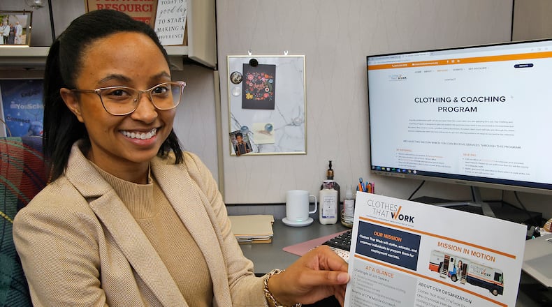 Kaitlyn Tyler, Talent and Education Coordinator for the Greater Springfield Partnership, shows some information about the Clothes That Work program Monday, Jan. 29, 2024. BILL LACKEY/STAFF