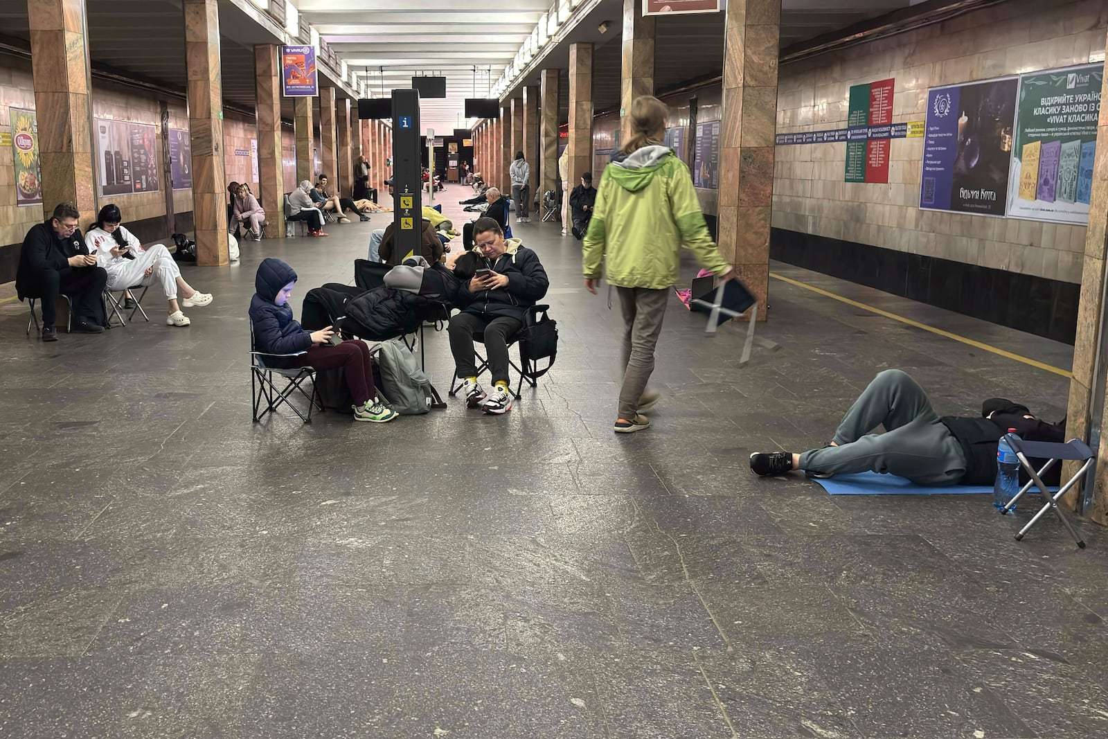 People take shelter at Kontraktova Ploshcha subway station during a Russian drone and missile attack in Kyiv, Ukraine, Saturday, May 24, 2025. (AP Photo/Illia Novikov)
