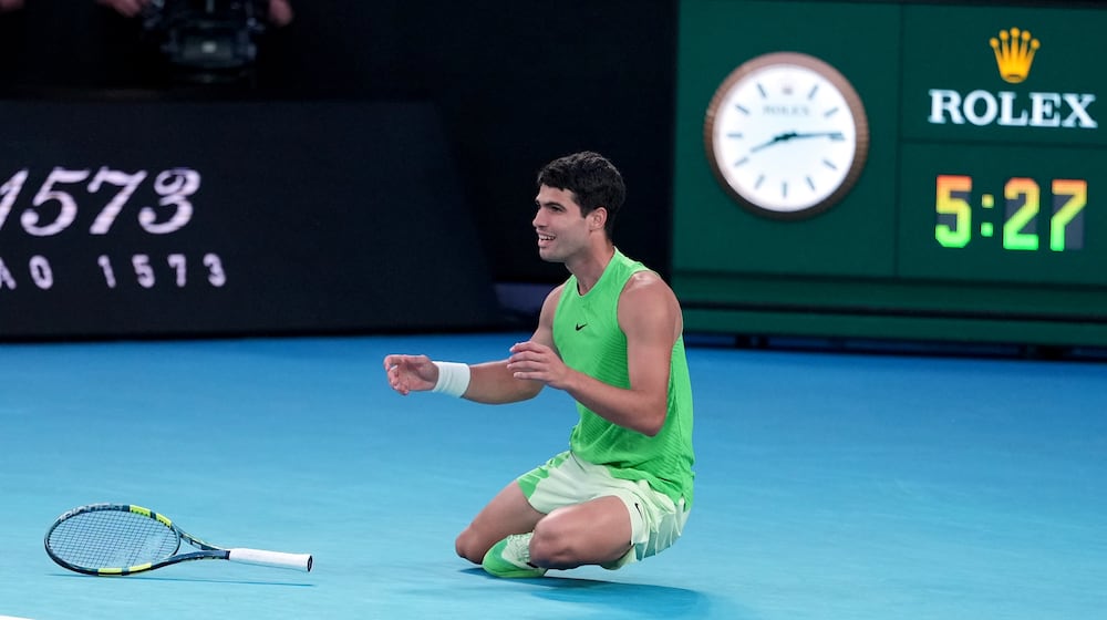 Carlos Alcaraz of Spain celebrates after defeating Alexander Zverev of Germany in their semifinal match at the Australian Open tennis championship in Melbourne, Australia, Friday, Jan. 30, 2026. (AP Photo/Asanka Brendon Ratnayake)
