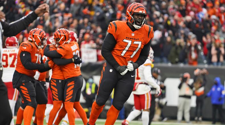 Cincinnati Bengals guard Hakeem Adeniji (77) celebrates after the Bengals defeated the Kansas City Chiefs 34-31 in an NFL football game, Sunday, Jan. 2, 2022, in Cincinnati. (AP Photo/Jeff Dean)