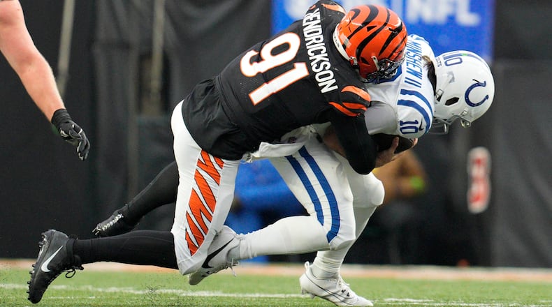 Cincinnati Bengals defensive end Trey Hendrickson (91) sacks Indianapolis Colts quarterback Gardner Minshew II (10) in the second half of an NFL football game in Cincinnati, Sunday, Dec. 10, 2023. (AP Photo/Jeff Dean)