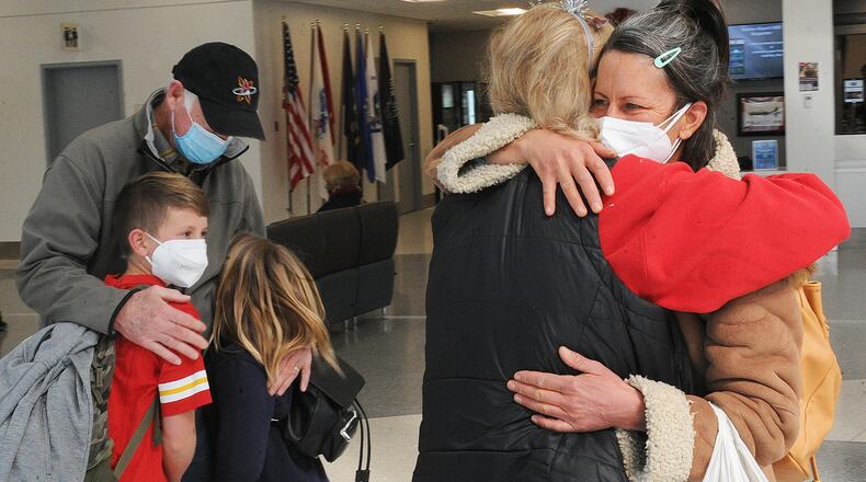 The holidays are for time with family and traveling. Tom and Barbara Macleod hug their daughter Emily Macleod and grandchildern Bo and Etta Macleod Haynie, after they arrived at the Dayton International Airport Monday, Dec. 20, 2021. MARSHALL GORBY\STAFF