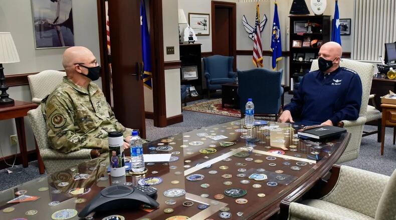 Gen. Arnold W. Bunch Jr., then-commander of the Air Force Materiel Command, talks with Gen. John W. "Jay" Raymond, chief of space operations, U.S. Space Force, inside AFMC headquarters at Wright-Patterson Air Force Base, in March 2021. (U.S. Air Force photo by Ty Greenlees)