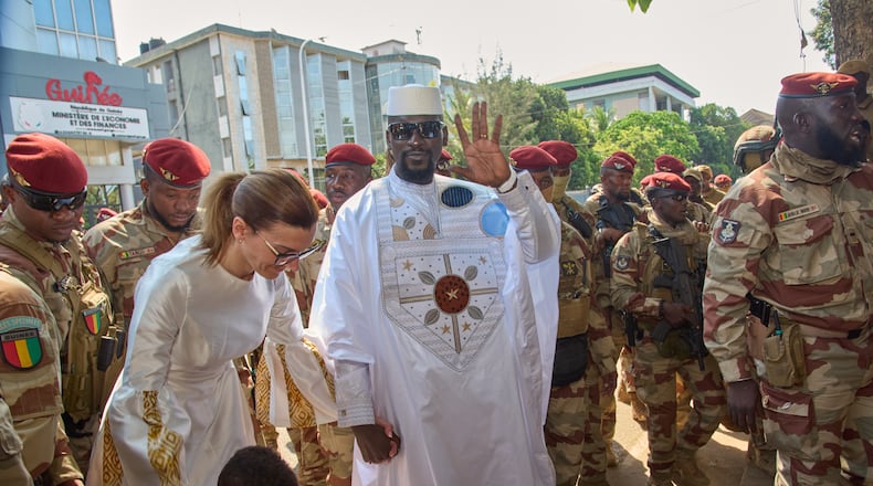 Guinea's President, Gen. Mamadi Doumbouya, arrives with his wife, Lauriane Doumbouya, to cast their votes in the presidential election in Conakry, Guinea, Sunday, Dec. 28, 2025. (AP Photo/Fode Toure)