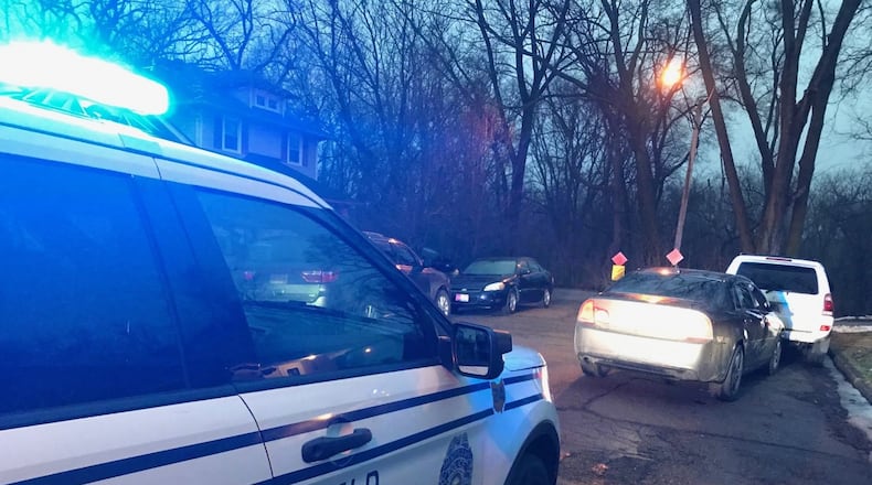 Springfield Police are looking for a suspect who escaped into the woods on Cecil Street on Tuesday evening after a pursuit involving a U.S. Marshall. Another suspect was taken into custody a short distance away. ERIC HIGGENBOTHAM/STAFF