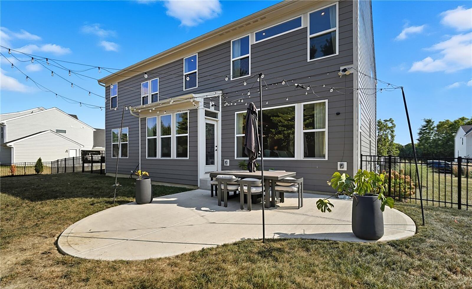 The back of the home has a concrete patio, aluminum fence and landscaping CONTRIBUTED