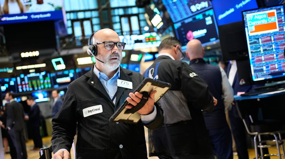 Federico DeMarco works on the floor at the New York Stock Exchange in New York, Wednesday, March 25, 2026. (AP Photo/Seth Wenig)