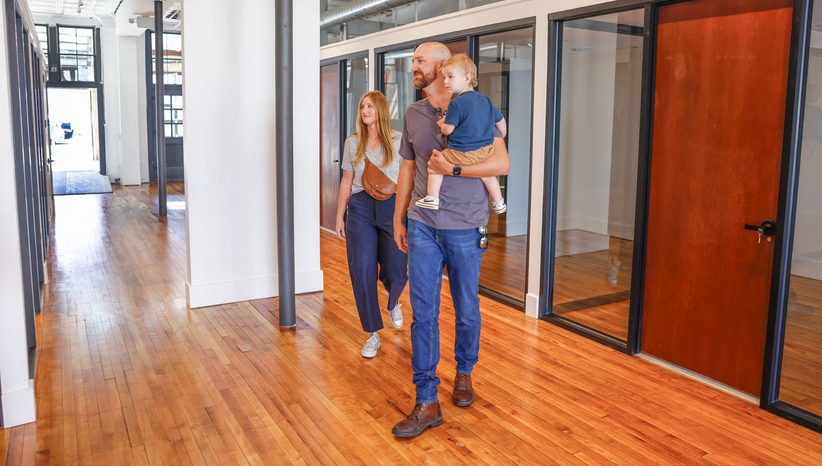 Alyssa and Steven Shepherd and their son August Shepherd, 1, check out the 211 CoWork area of the Willman Building during its grand opening on Friday, September 12, 2025, in Urbana. JOSEPH COOKE/STAFF