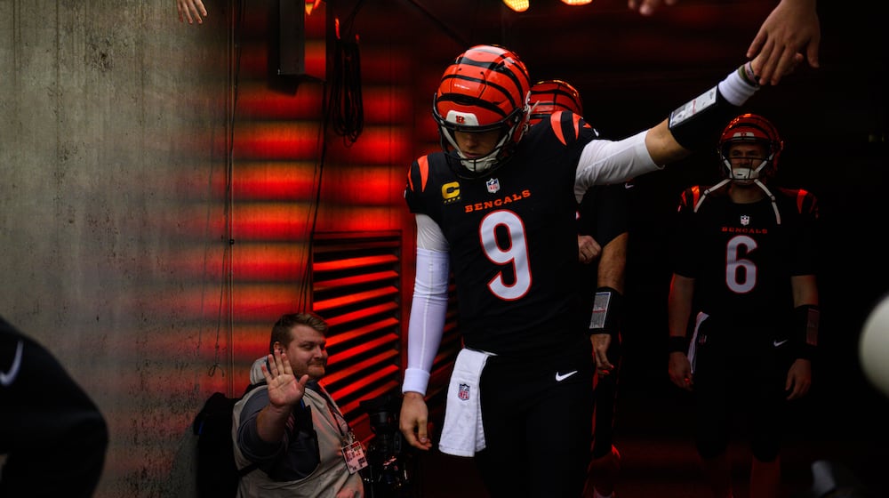Bengals quarterback Joe Burrow runs out of the tunnel for pregame warmups before during their game against the Arizona Cardinals on Sunday, Dec. 28 at Paycor Stadium. JEREMY MILLER / CONTRIBUTED PHOTO