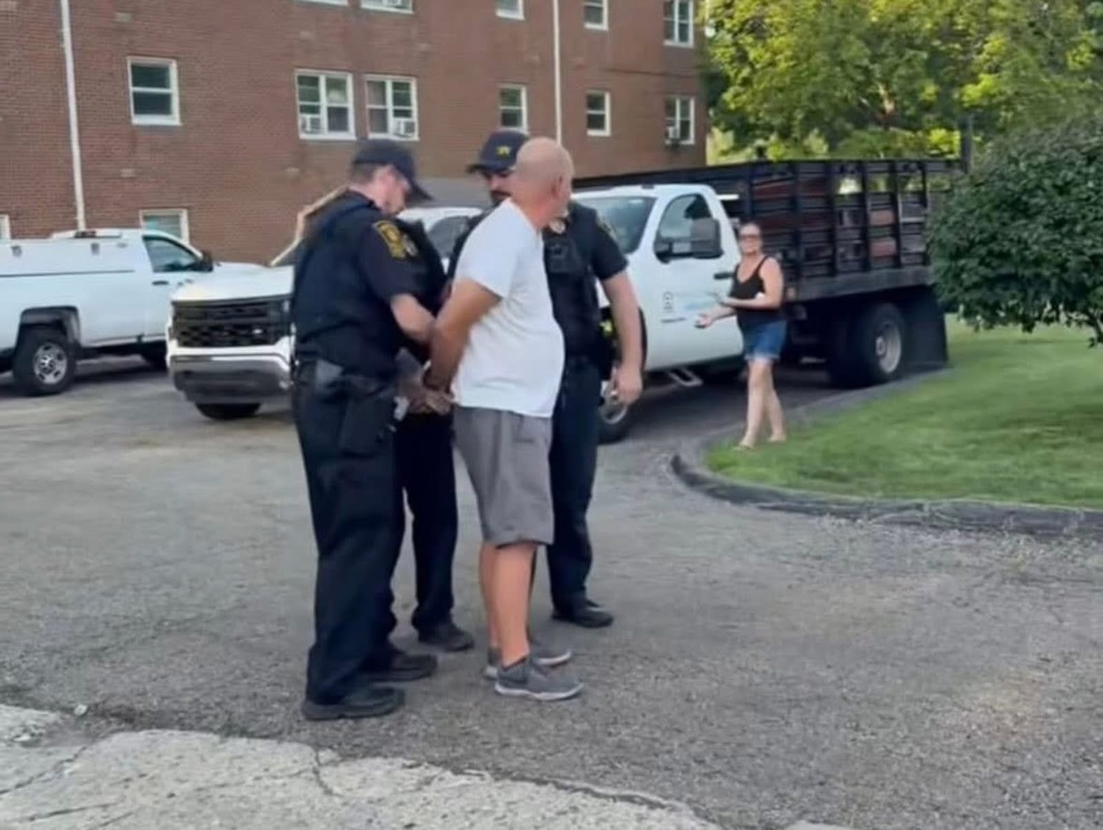 In this contributed photo, Jimmy Steward is arrested by Springfield Police Division officers, charged with assault of a protester near his apartment. His wife, Springfield Domestic Violence Coalition founder Beth Donahue, is in the background. CONTRIBUTED