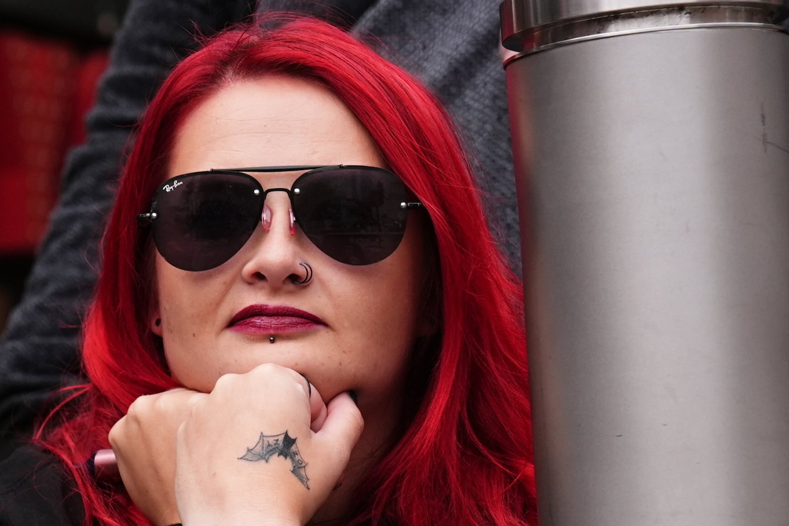 A fan waits near the Black Sabbath Bridge bench on Broad Street ahead of the funeral procession for Black Sabbath frontman Ozzy Osbourne, in Birmingham, England, Wednesday July 30, 2025. (Jacob King/PA via AP)
