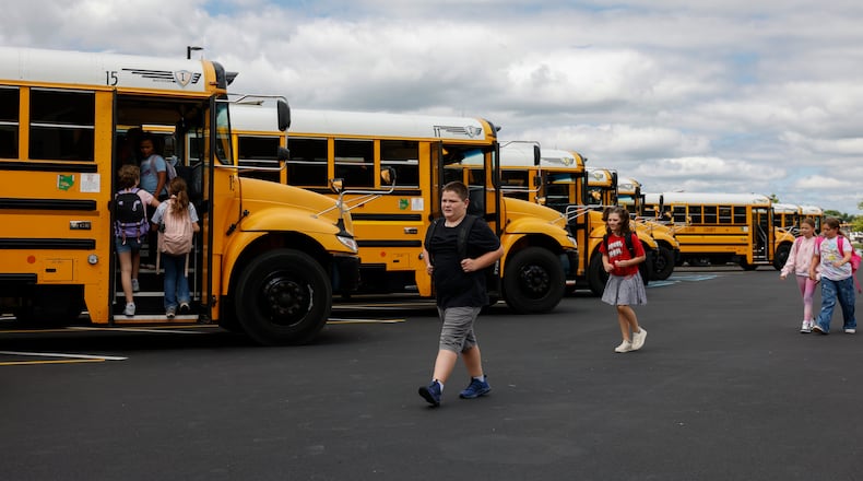 Students head toward buses at the end of the first week of classes at Northeastern Elementary School on Friday, August 22, 2025, in South Vienna. JOSEPH COOKE/STAFF