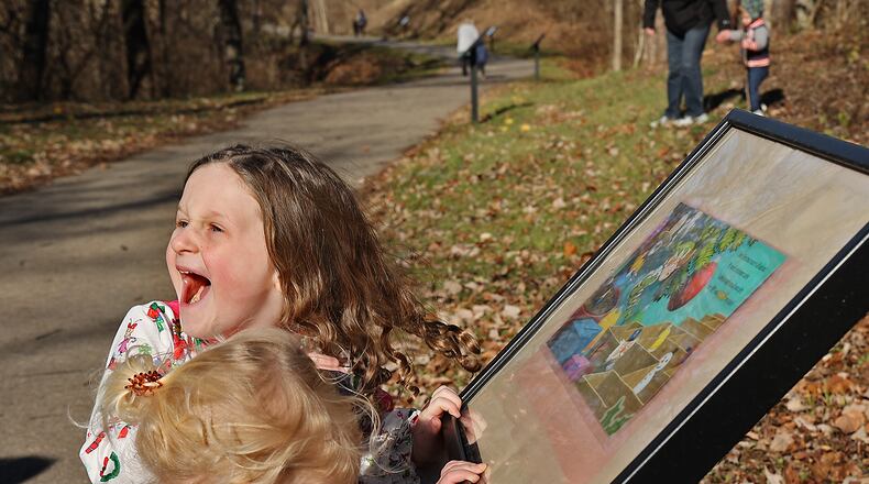 Several evenst will be held this weekend in Clark and Champaign Counties, including an Arrows Adventure Trail at Smith Park StoryWalk. Here, Zailey Patterson, 5, laughed as she and Heidi Fabrizio, 2, followed along with their mothers as they read a page from a book on the Tecumseh Trail Story Walk at Smith Park a few years ago. BILL LACKEY/STAFF