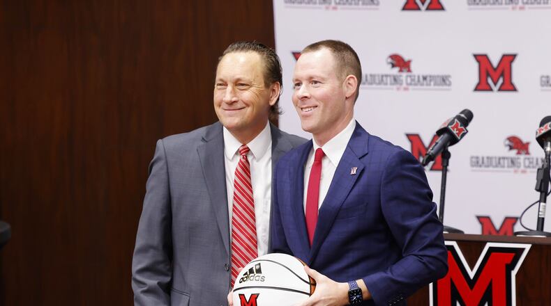 Miami University Director of Athletics David Sayler, left, stands with new Miami University Redhawks men's basketball coach Travis Steele during a press conference Friday, April 1, 2022 at the Randy Gunlock Family Athletic Center on the Miami University campus in Oxford. NICK GRAHAM/STAFF