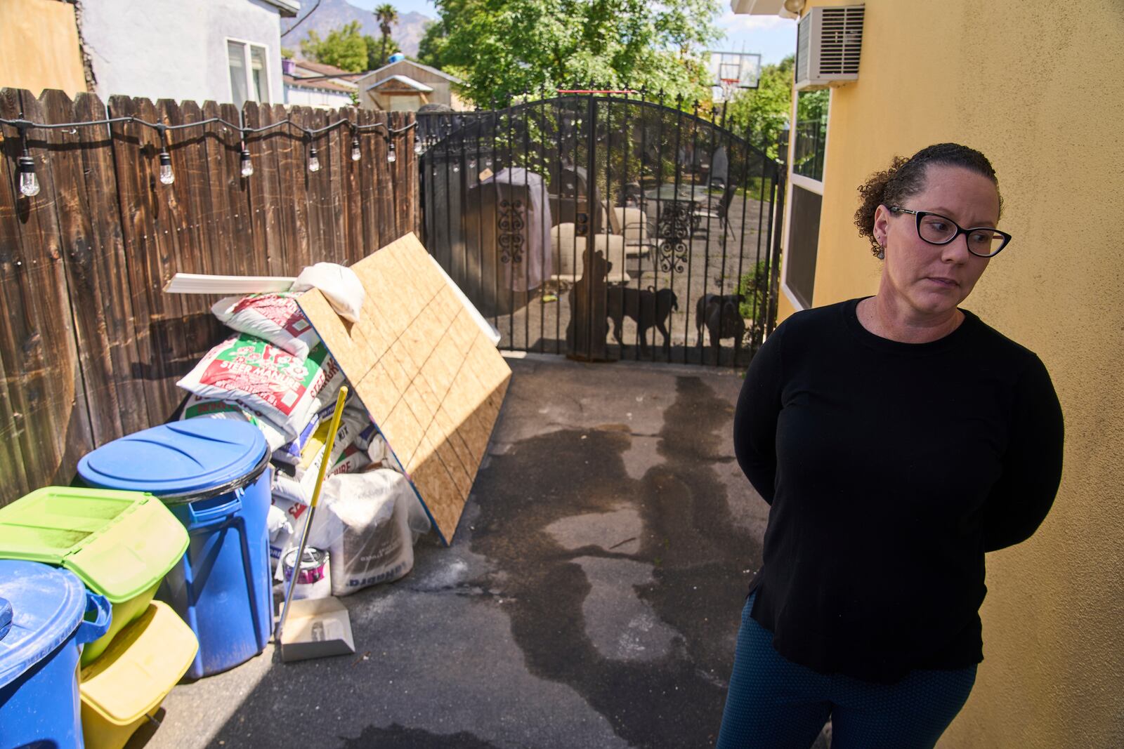 Eaton fire survivor Dr. Nicole Maccalla, a data scientist and a lead investigator, checks the exterior repairs made to her smoke damaged home in Altadena, Calif., on Friday, April 4, 2025. (AP Photo/Damian Dovarganes)