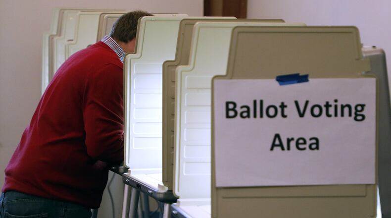 A man stands by himself as he casts in vote at a Springfield election poll Tuesday. Bill Lackey/Staff