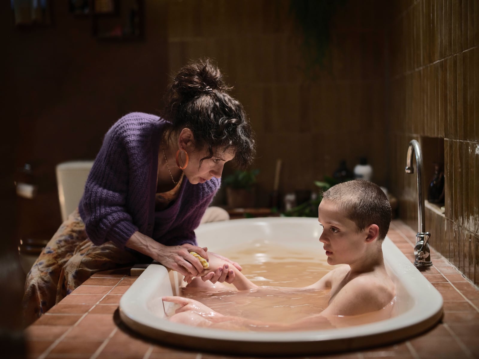 This image released by A24 shows Sally Hawkins, left, and Jonah Wren Phillips in a scene from "Bring Her Back." (Ingvar Kenne/A24 via AP)