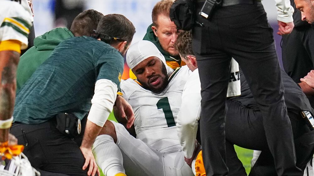 Green Bay Packers' Micah Parsons reacts after an injury during the second half of an NFL football game against the Denver Broncos Sunday, Dec. 14, 2025, in Denver. (AP Photo/Jack Dempsey)