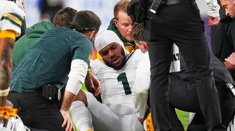 Green Bay Packers' Micah Parsons reacts after an injury during the second half of an NFL football game against the Denver Broncos Sunday, Dec. 14, 2025, in Denver. (AP Photo/Jack Dempsey)