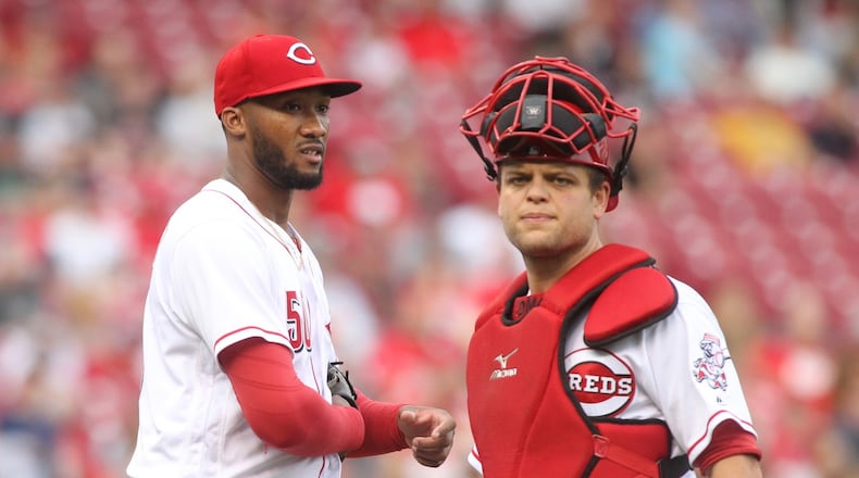 Reds pitcher Amir Garrett and Devin Mesoraco pause after Garrett was hit on the hand by a groundball during a game against Indians on Tuesday, May 23, 2017, at Great American Ball Park in Cincinnati. David Jablonski/Staff