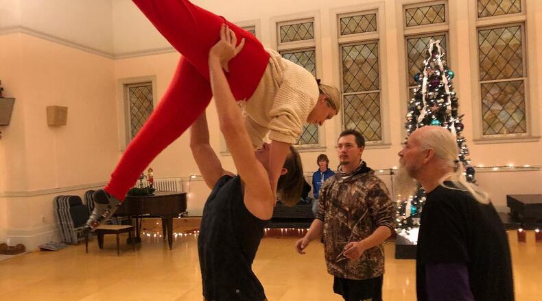 Kaitlin Musik gets a lift from Nethaniel Tackett while Ray Jones adds support and show director D. Scot Davidge surveys the action during a rehearsal of the Ohio Performing Arts Institute's 32nd annual production of "The Nutcracker." Photo by Brett Turner