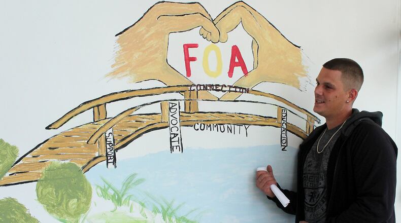 Michael Lemmings a recovering addict and Families of Addicts member painted a mural for the groups new home on High Street. JEFF GUERINI/STAFF