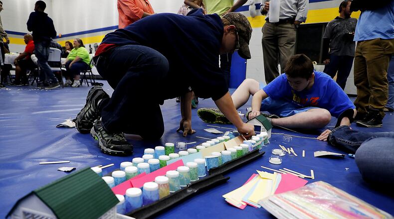 Residents at Oesterlen Services for Youth work on building a pathway for a NANO Bug to follow Thursday during the Oesterlen County Fair. Bill Lackey/Staff