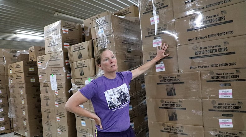 Jeanne Rue talks about the distribution of their Rue Farms Rustic Potato Chips to at least seven states Wednesday in the warehouse of their new 11 thousand square foot facility on US 68. BILL LACKEY/STAFF