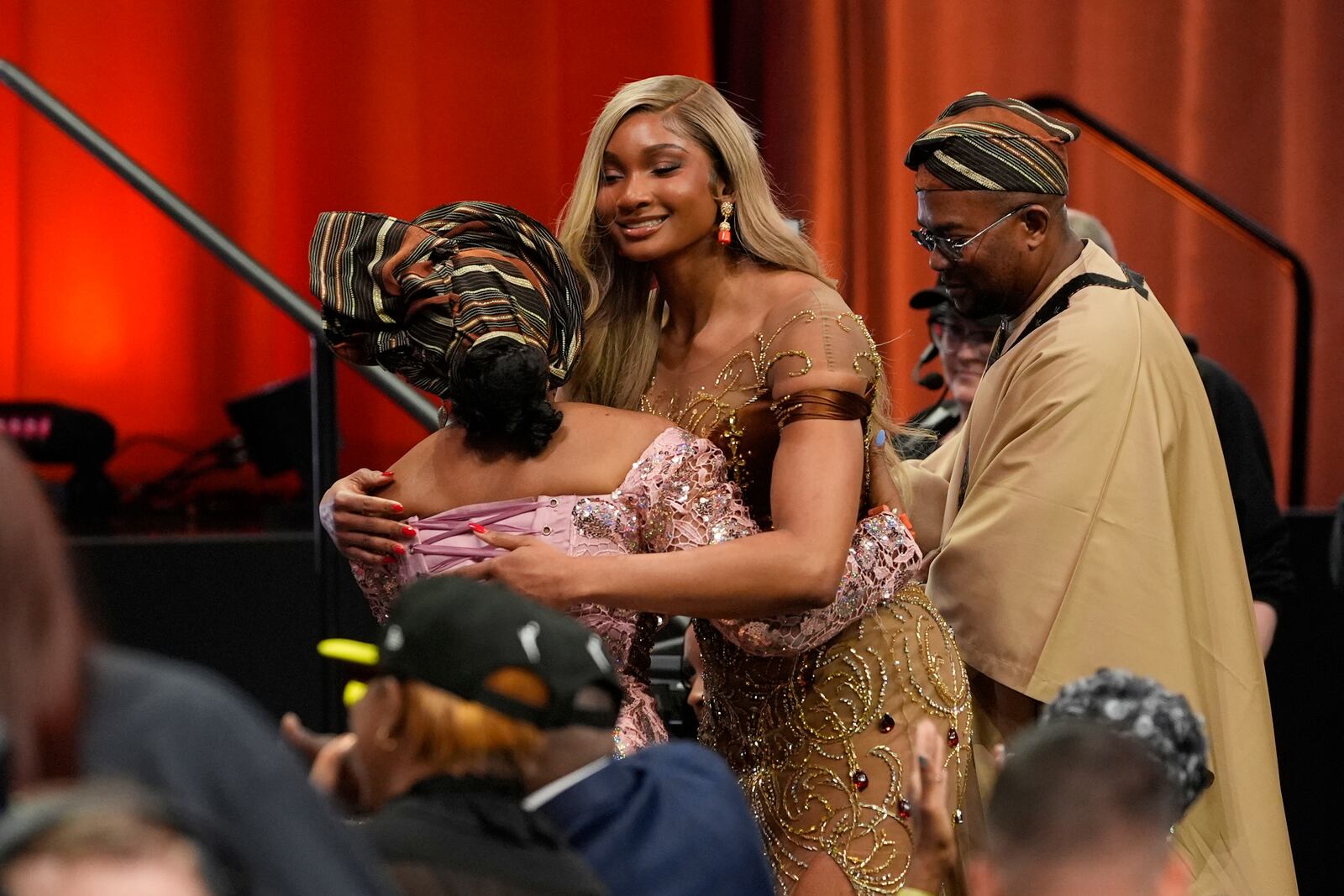 Southern California's Kiki Iriafen, center, celebrates after being selected fourth overall by the Washington Mystics during the first round of the WNBA basketball draft, Monday, April 14, 2025, in New York. (AP Photo/Pamela Smith)