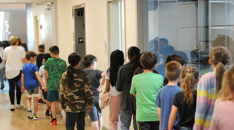 Students at the Fairborn Intermediate School head back to class after lunch. Advocates are making a public push for Ohio to begin providing free school breakfasts and lunches for all public school students at an estimated cost of about $300 million per year.
MARSHALL GORBY\STAFF