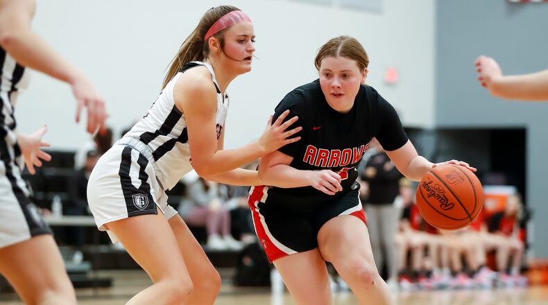 Tecumseh High School senior Madilynn Moore is guarded by Greenon sophomore Avery Minteer during their game on Wednesday night at Greenon High School. The Arrows won 56-53. CONTRIBUTED PHOTO BY MICHAEL COOPER