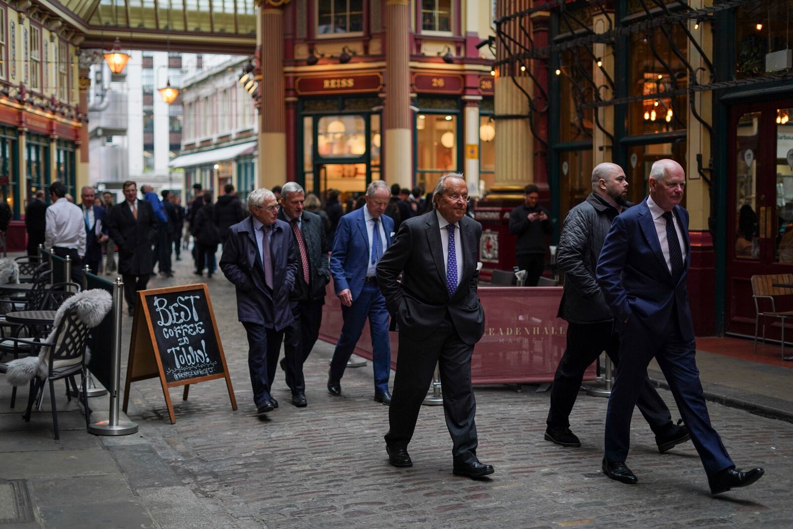 People walk in Leadenhall Market at lunch time, in the financial district, known as The City in London, Wednesday, April 9, 2025. (AP Photo/Alberto Pezzali)