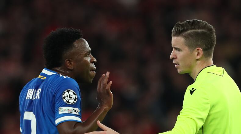 Real Madrid's Vinicius Junior argues with referee François Letexier after scoring the opening goal during a Champions League playoff soccer match between SL Benfica and Real Madrid in Lisbon, Portugal, Tuesday, Feb. 17, 2026. (AP Photo/Pedro Rocha)