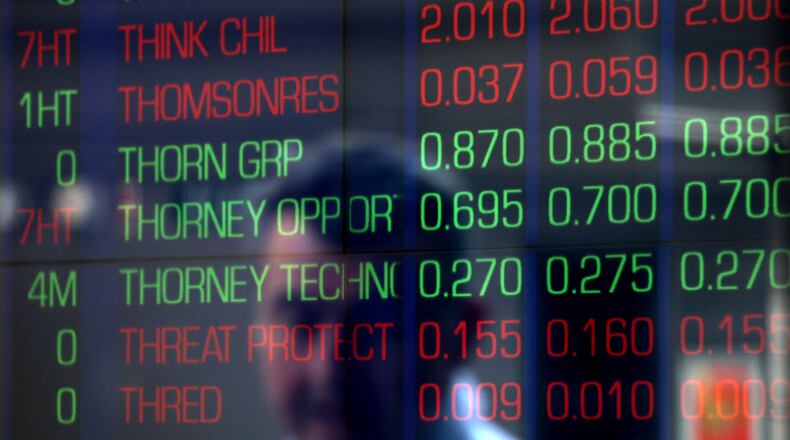 A man is reflected in a window at a public gallery at the Australian Stock Exchange in Sydney, Tuesday, Feb. 6, 2018. Australian shares have fallen almost 3 percent and shed four months of gains in morning trading, following the lead of U.S markets which suffered their worst sell-off in six-and-a-half years. (AP Photo/Rick Rycroft)