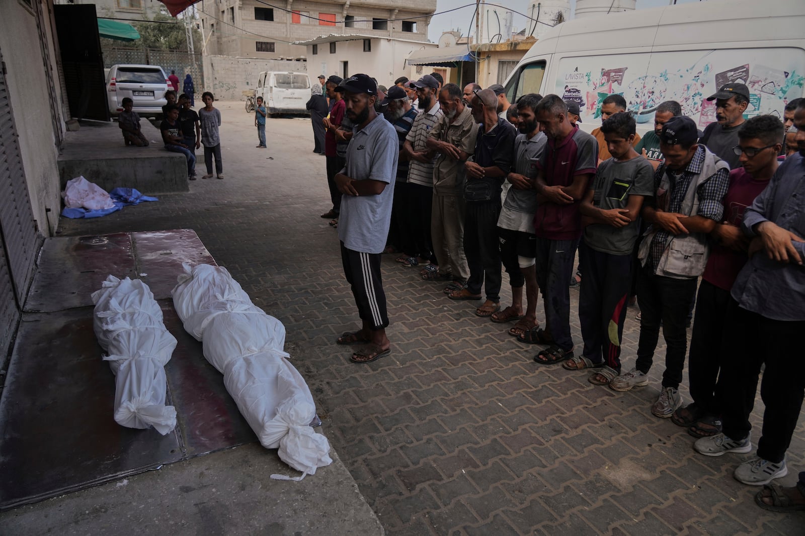 Mourners attend the funeral of their relatives killed in an Israeli bombardment, in Deir al-Balah, central Gaza Strip, Monday, July 21, 2025. (AP Photo/Abdel Kareem Hana)