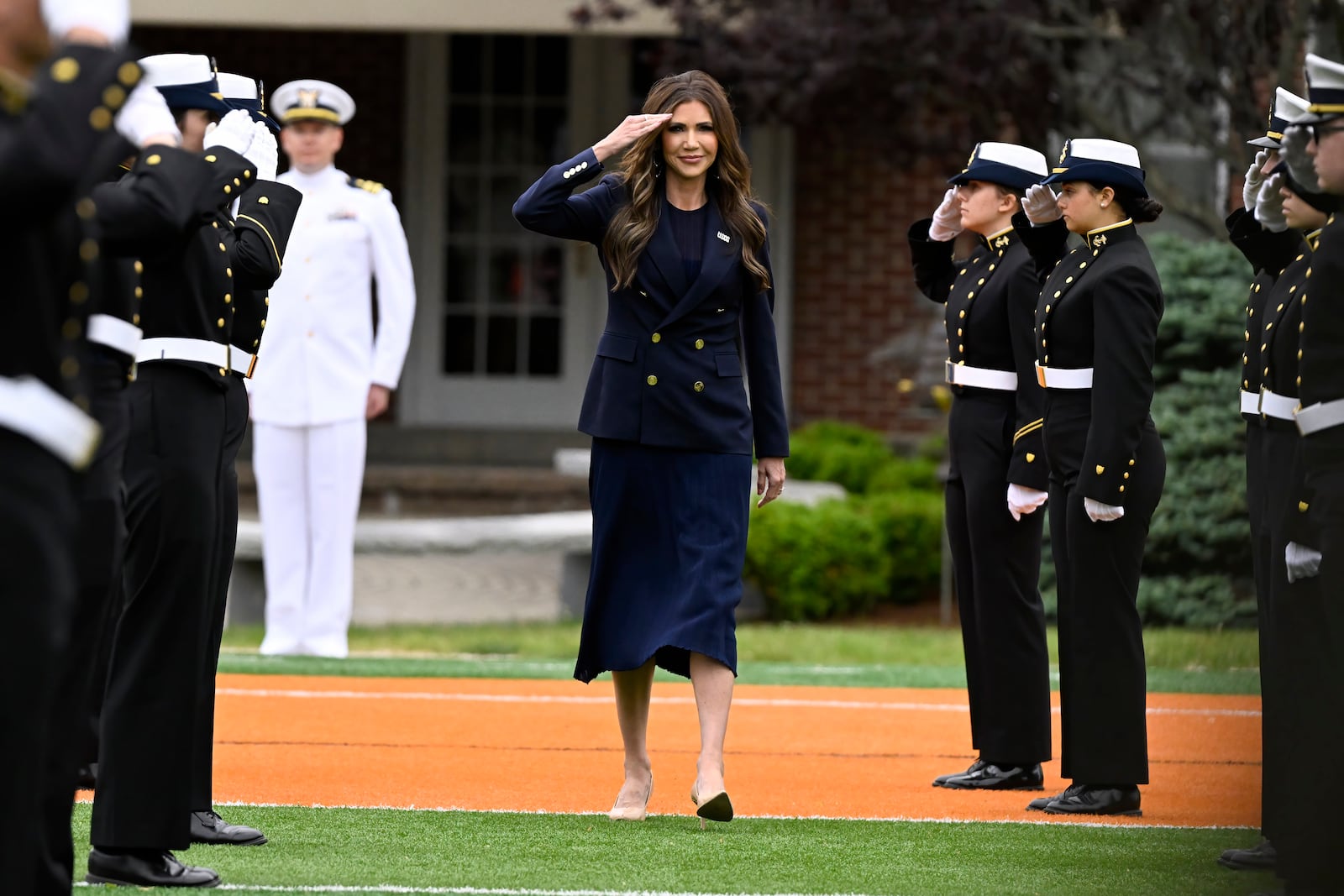 Homeland Security Secretary Kristi Noem salutes as she arrives at the commencement for the United States Coast Guard Academy, Wednesday, May 21, 2025 in New London, Conn. (AP Photo/Jessica Hill)