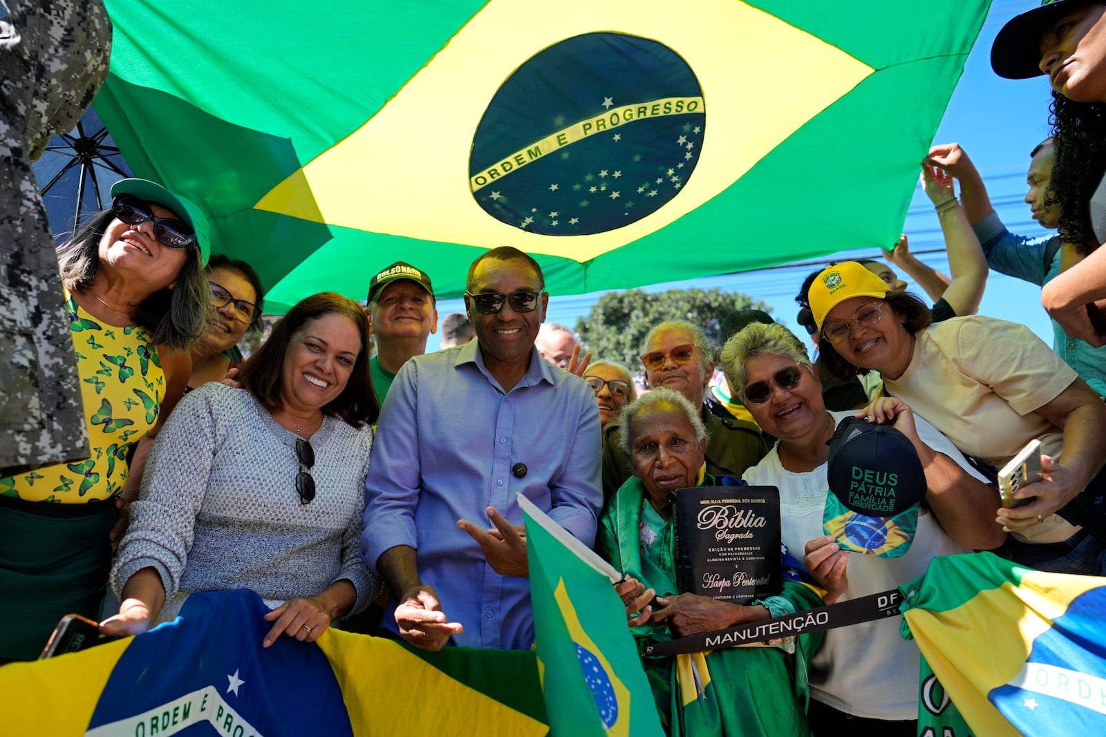 Supporters of former President Jair Bolsonaro pose for a photo in front of the hospital, before the ex-president's departure after a weeks-long surgical stay, in Brasilia, Brazil, Sunday, May 4, 2025. (AP Photo/Eraldo Peres)