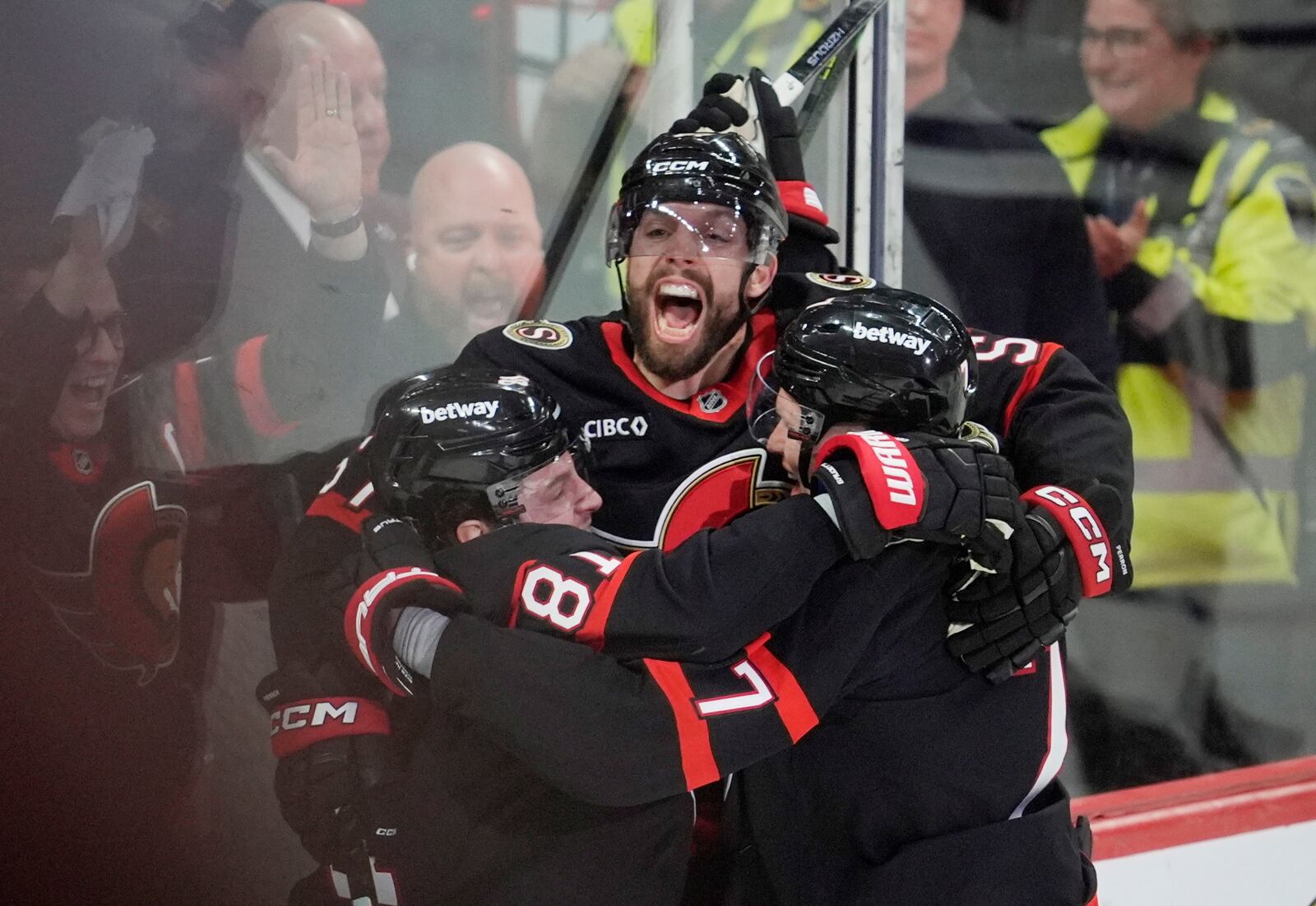 Ottawa Senators' David Perron (57) celebrates his goal with Adam Gaudette (81) and Brady Tkachuk (7) after scoring against the Toronto Maple Leafs during third period NHL playoff action in Ottawa, Saturday, April 26, 2025. (Adrian Wyld/The Canadian Press via AP)