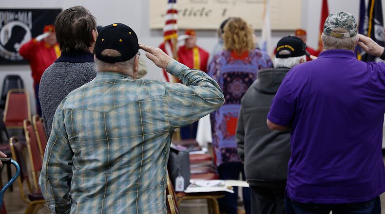 Local veterans salute as the colors are presented during the Vietnam Veterans Day of Remembrance ceremony Saturday, March 25, 2023 at VFW Post 1031 in Springfield. BILL LACKEY/STAFF