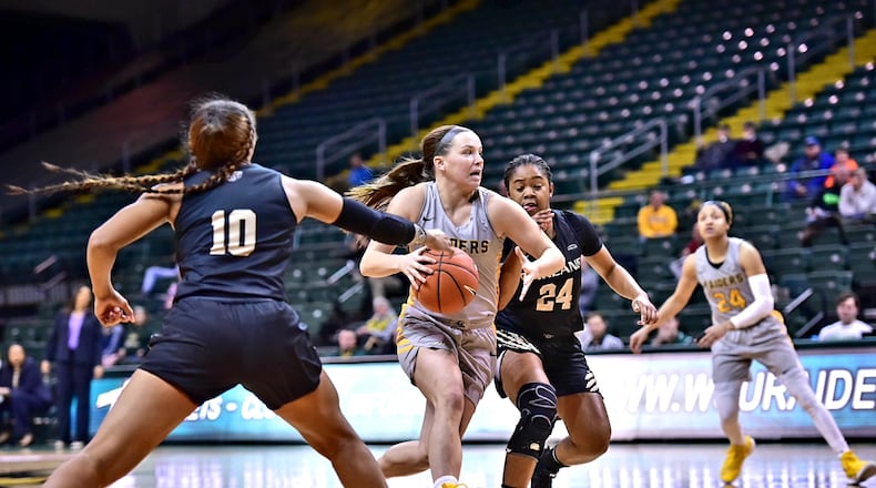 Wright State guard Mackenzie Taylor drives through the Oakland defense Friday night at the Nutter Center. Joseph Craven/CONTRIBUTED