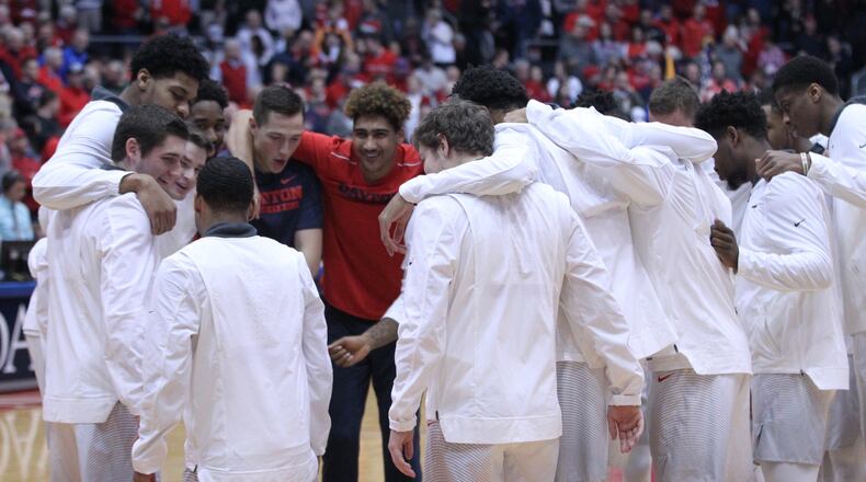 Dayton huddles before a game against Rhode Island on Saturday, Jan. 20, 2018, at UD Arena. David Jablonski/Staff